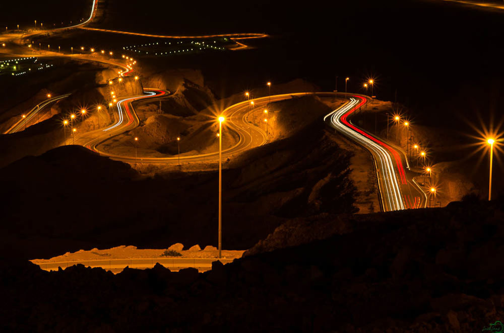 LIGHT TRAILS ON STREET AT NIGHT