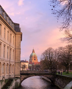 Buildings in city against sky during sunset