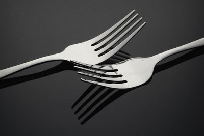 Fork over black background with light and shadow