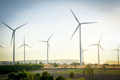 Windmills against sky