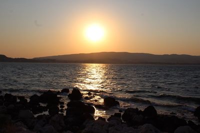 Scenic view of sea against clear sky during sunset