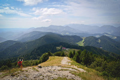 Scenic view of man hiking in mountains