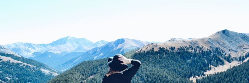 Rear view of woman against snow covered mountains and sky