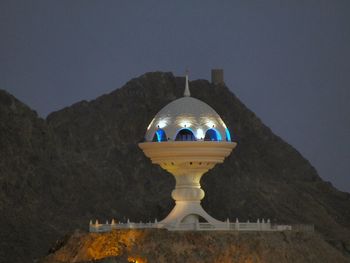 Low angle view of illuminated building against sky at dusk