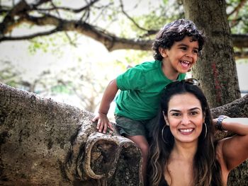 Portrait of smiling mother with son in park