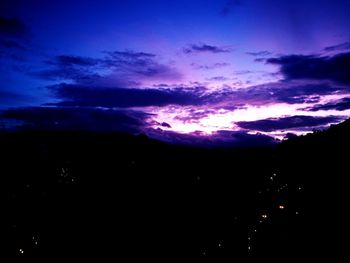 Silhouette landscape against sky at night