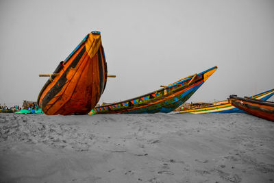 Multi colored umbrellas on beach against clear sky