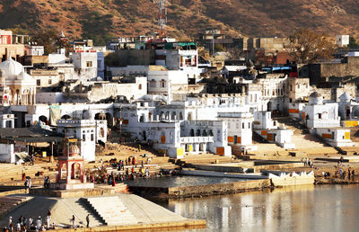 White buildings by lake