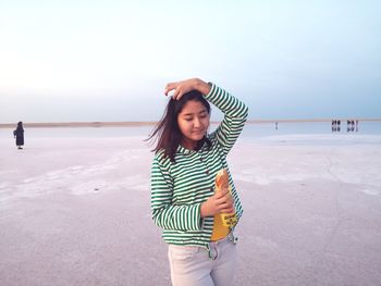 Full length of woman standing on beach