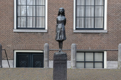 Statue of man outside house