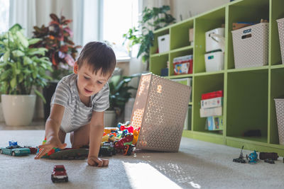 Side view of boy playing with toy on table