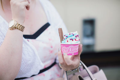 Midsection of woman holding ice cream