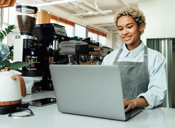 Young woman using laptop at home