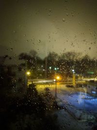 Close-up of wet glass window in rainy season