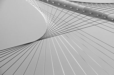 Low angle view of suspension bridge against sky