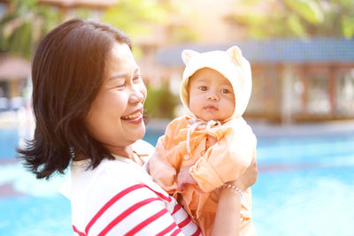 Portrait of mother and daughter at swimming pool
