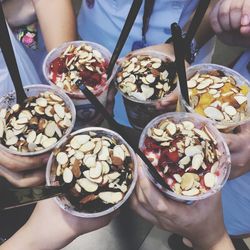 Low section of people holding ice cream