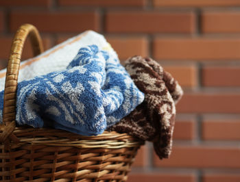 Close-up of wicker basket against wall