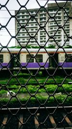 Full frame shot of chainlink fence against building