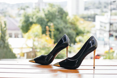 Close-up of black shoes on table