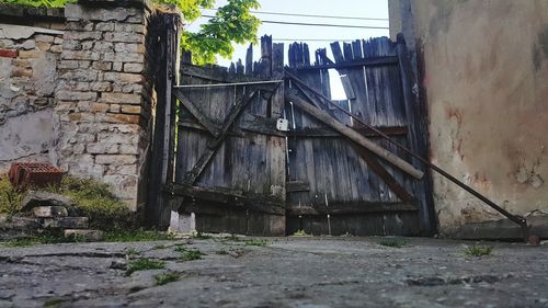 Abandoned building by wall