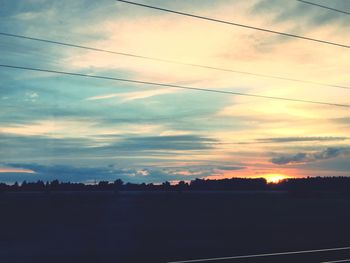 Silhouette of trees against sky at sunset