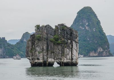 Rock formations in sea against sky