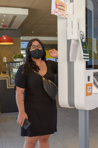 Mallorca, spain, 07-27-2021, young woman placing an order on a touch screenw in a macdonald's  