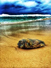 Scenic view of sea against cloudy sky