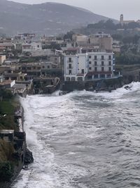 Sea by buildings in city