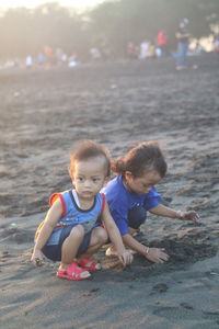 Siblings enjoying at beach