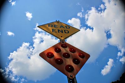 Low angle view of road sign against sky