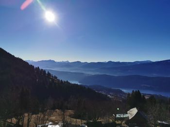 Scenic view of mountains against blue sky