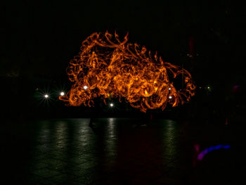 Illuminated fire in water at night