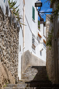 Low angle view of steps amidst buildings