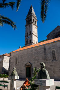 Low angle view of statue in front of building