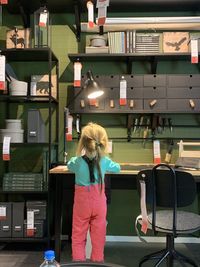 Rear view of girl standing in office