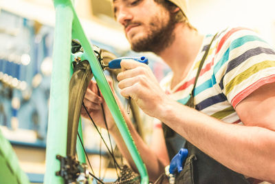 Man repairing bicycle at workshop