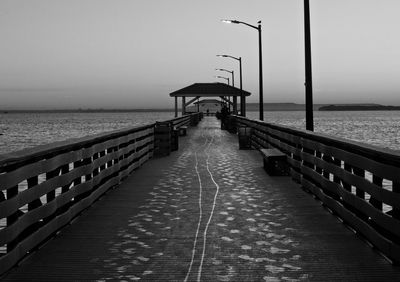 Pier over sea against clear sky