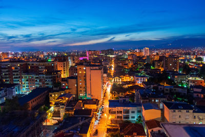 High angle view of illuminated city buildings at dusk