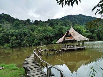 Gazebo by lake against sky