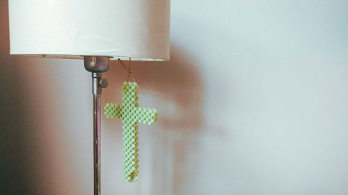 Close-up of electric lamp hanging on wall