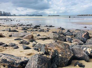 Rocks on beach against sky