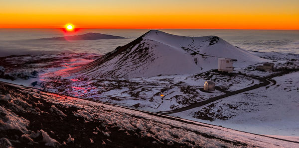 Scenic view of snowcapped mountains against sky during sunset