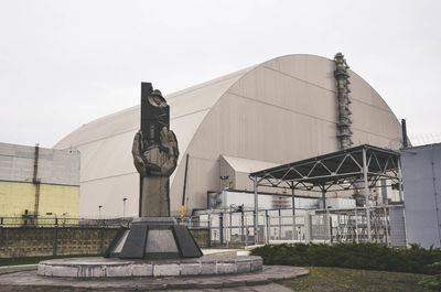 Low angle view of sculpture against building