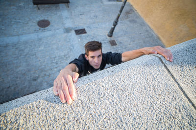 High angle view of young man lying on floor