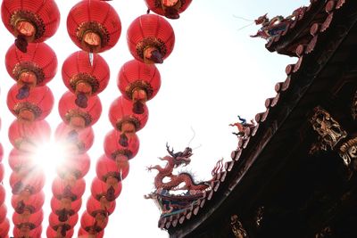 Low angle view of lanterns hanging against sky