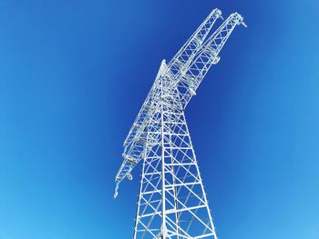 Low angle view of blue sky electricity power line