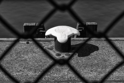 High angle view of chainlink fence on table