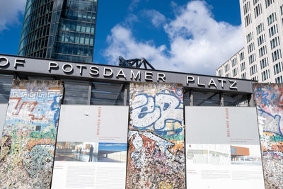 Low angle view of graffiti on wall against buildings